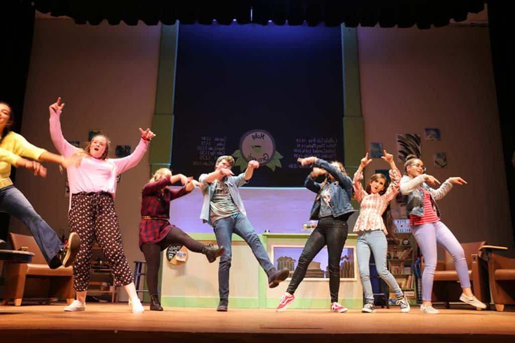 Group of theater kids performing Godspell